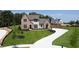 Luxury home on a large lot with a curved driveway and mature trees at 64 Telfair Ct, Acworth, GA 30101