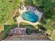Aerial view of backyard oasis featuring a freeform pool, stone patio, and a private deck at 3950 Stanford Dr, Cumming, GA 30041