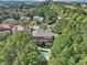 Aerial view of a large home with a pool, deck, and surrounded by lush greenery at 3950 Stanford Dr, Cumming, GA 30041