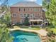 Beautiful brick home with an upper deck, lower patio, and a backyard swimming pool at 3950 Stanford Dr, Cumming, GA 30041