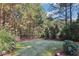 Beautifully manicured backyard with lush green grass surrounded by tall trees at 3950 Stanford Dr, Cumming, GA 30041