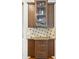 Stylish bar area with wood cabinets, display shelving, and granite counters, ideal for entertaining guests at 3950 Stanford Dr, Cumming, GA 30041