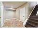 Basement landing with tiled floor and access to the stairwell at 3950 Stanford Dr, Cumming, GA 30041