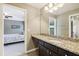 Bathroom features granite counters, a large mirror, and access to bedroom at 3950 Stanford Dr, Cumming, GA 30041