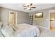 Neutral bedroom with a ceiling fan, tv, and ensuite access at 3950 Stanford Dr, Cumming, GA 30041