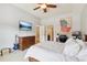 Bedroom with ceiling fan, tv, and desk, with a blue electric guitar at 3950 Stanford Dr, Cumming, GA 30041