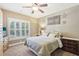 Comfortable bedroom featuring a ceiling fan, shuttered windows and two decorative wooden nightstands at 3950 Stanford Dr, Cumming, GA 30041