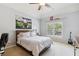 Bedroom with ceiling fan, large bed, and decorated with UGA decor at 3950 Stanford Dr, Cumming, GA 30041