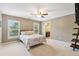 Comfortable bedroom offers natural light, neutral paint, and ensuite access at 3950 Stanford Dr, Cumming, GA 30041