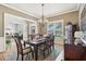 Elegant dining room with a chandelier, hardwood floors, and a view into the home office at 3950 Stanford Dr, Cumming, GA 30041