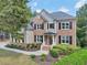 Charming two-story home with a brick and siding exterior and well-manicured landscaping at 3950 Stanford Dr, Cumming, GA 30041