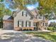 Elegant two-story home with a two-car garage, brick accents, and a well-maintained lawn at 3950 Stanford Dr, Cumming, GA 30041