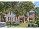 Charming two-story home with brick and siding exterior, a well-manicured lawn, and mature trees at 3950 Stanford Dr, Cumming, GA 30041