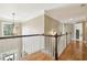 Hallway with wood floors and white banister, showcasing the home's bright and open layout at 3950 Stanford Dr, Cumming, GA 30041