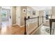 Upstairs hallway featuring wood floors and views into the laundry room and other areas of the home at 3950 Stanford Dr, Cumming, GA 30041
