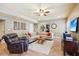 Cozy living room with a tile floor, ceiling fan, recessed lighting and an off-white sectional couch at 3950 Stanford Dr, Cumming, GA 30041