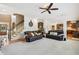 Open living room with hardwood floors, a staircase to the second floor, and access to other rooms at 3950 Stanford Dr, Cumming, GA 30041
