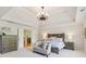 Spacious main bedroom with hardwood furnishings, tray ceiling, and ensuite access at 3950 Stanford Dr, Cumming, GA 30041