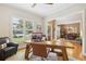 Home office featuring a wooden desk, leather chairs, and view into dining room at 3950 Stanford Dr, Cumming, GA 30041