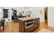 Open floor plan view of kitchen island, dining area and living space with abundant natural light at 3950 Stanford Dr, Cumming, GA 30041