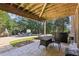 Covered patio featuring a table, grill and a view of the pool and backyard at 3950 Stanford Dr, Cumming, GA 30041