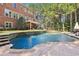 Large, kidney-shaped pool with stone decking at 3950 Stanford Dr, Cumming, GA 30041