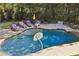 Backyard pool and lounging area surrounded by mature trees, providing a private and relaxing oasis at 3950 Stanford Dr, Cumming, GA 30041