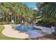 Inviting backyard pool with a basketball hoop and beautiful stone patio surrounded by lush landscaping at 3950 Stanford Dr, Cumming, GA 30041