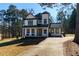 Two-story house with a long driveway, nestled among tall trees at 8404 Majors Rd, Cumming, GA 30041