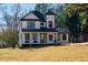 Two-story farmhouse with dark green roof and white siding at 8404 Majors Rd, Cumming, GA 30041