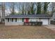 Ranch style home with gray exterior, red door, and attached garage at 1512 Pine Glen Cir, Decatur, GA 30035