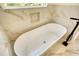 Relaxing bathroom featuring a freestanding soaking tub and marble tile at 520 Mountainview Dr, Covington, GA 30016