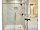 Spa-like bathroom with a large walk-in shower and marble tile at 520 Mountainview Dr, Covington, GA 30016