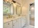 Double vanity bathroom with gold fixtures, quartz countertops, and marble tile flooring at 520 Mountainview Dr, Covington, GA 30016