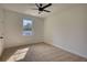 Spacious bedroom featuring a ceiling fan and large window at 520 Mountainview Dr, Covington, GA 30016