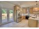 Modern kitchen with light wood cabinets, quartz countertops, and stainless steel appliances at 520 Mountainview Dr, Covington, GA 30016