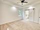 Spacious main bedroom with neutral carpeting, barn door to en-suite bathroom, and ceiling fan at 520 Mountainview Dr, Covington, GA 30016