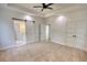 Bright main bedroom featuring neutral carpet, barn door to en-suite, and double closets at 520 Mountainview Dr, Covington, GA 30016