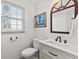 Updated bathroom with white vanity and dark bronze fixtures at 718 Creek Nw Trl, Kennesaw, GA 30144