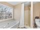 Relaxing bathroom featuring a bathtub and shower at 718 Creek Nw Trl, Kennesaw, GA 30144