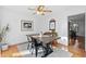 Bright dining room with wood table and black chairs at 718 Creek Nw Trl, Kennesaw, GA 30144