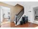 Hardwood floor entryway with staircase and plant at 718 Creek Nw Trl, Kennesaw, GA 30144