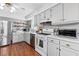 Modern kitchen with stainless steel appliances and light gray cabinets at 718 Creek Nw Trl, Kennesaw, GA 30144