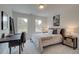 Bright bedroom with a gray upholstered bed frame, a desk and chair, and natural light from the windows at 405 Carrera Ln, Acworth, GA 30102