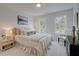 Bedroom featuring an upholstered bed, neutral bedding, and windows for natural light at 405 Carrera Ln, Acworth, GA 30102