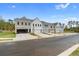 Row of townhouses with attached garages and landscaping at 405 Carrera Ln, Acworth, GA 30102