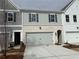 This exterior features attached garages, multiple windows, and newly installed landscaping at 405 Carrera Ln, Acworth, GA 30102