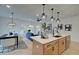 Modern kitchen and dining area featuring pendant lights, quartz counters, stainless appliances, and seamless flow to the living room at 405 Carrera Ln, Acworth, GA 30102