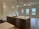 Large kitchen island with seating, stainless steel appliances, and pendant lighting at 405 Carrera Ln, Acworth, GA 30102