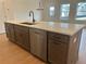 Kitchen island features stainless steel appliances, sleek cabinets, and quartz countertop at 405 Carrera Ln, Acworth, GA 30102